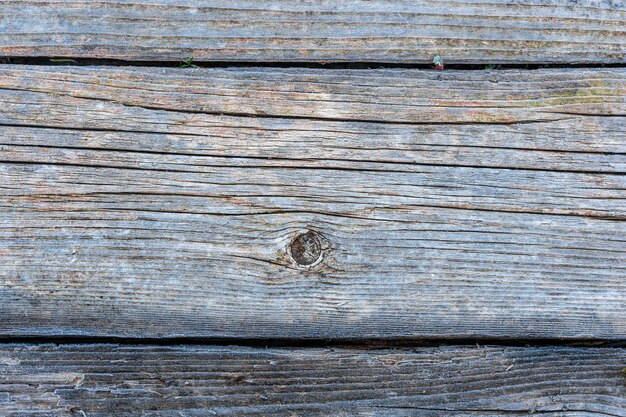 Pale faded brown and cool blue reclaimed pine wood surface with aged boards lined up weathered