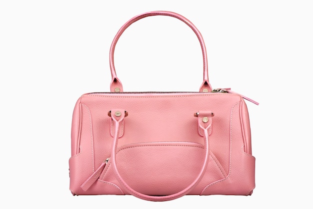白い背景の上の淡いピンクの女性のハンドバッグ