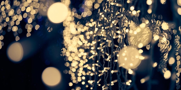 Pale yellow lights bokeh from christmas holiday garlands blurred festive abstract background lights