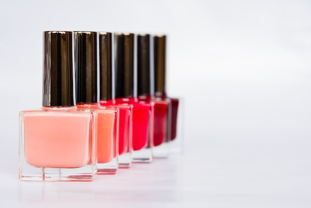 A palette of nail polish bottles on a white background