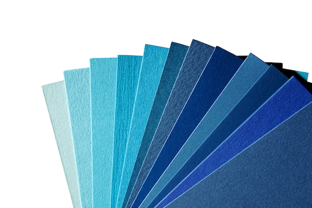 A palette of shades of blue paper on a white background