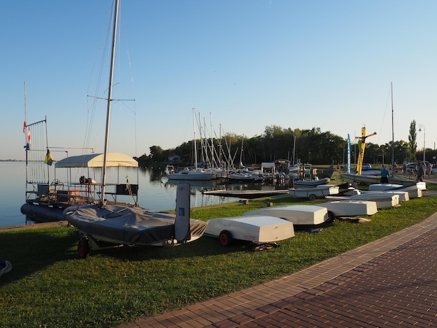 Palic Serbia September 11 2021 Boats and yachts on the shores of Lake Palic Rest on the water Sports water transport moored off the coast Tourism and active lifestyle Horizon line sky and water