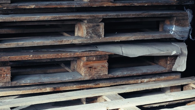 Pallet rack warehouse logistics center Huge large modern warehouse Empty wooden pallets are stacked in a warehouse Lots of empty pallets stacked inside the store