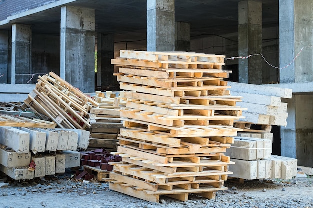 Pallets reinforced concrete blocks building brackets at a construction site