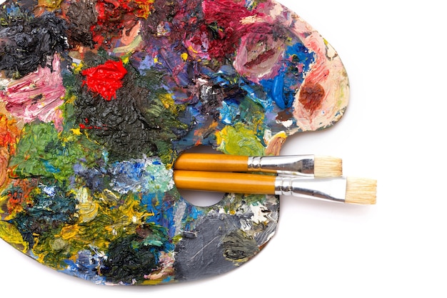 Pallette with brushes on a white background