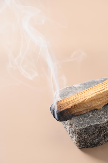 Palo Santo stick incense burning on stone