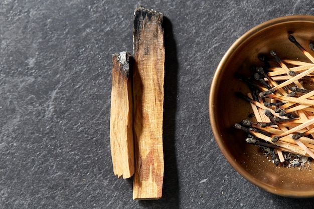 palo santo sticks and cup with burnt matches