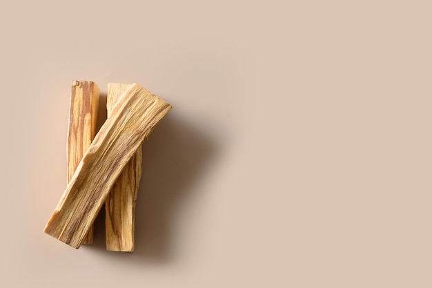 Palo Santo sticks for ritual cleansing meditation spiritual practice on beige background with copy space Minimal style View from above