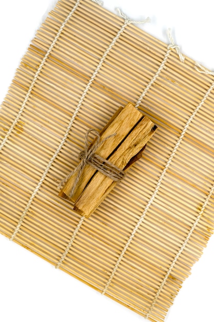 Palo Santo wood sticks on bamboo mat with aromatherapy accessories