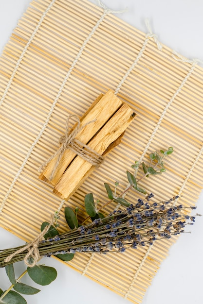 Palo Santo wood sticks on bamboo mat with aromatherapy accessories