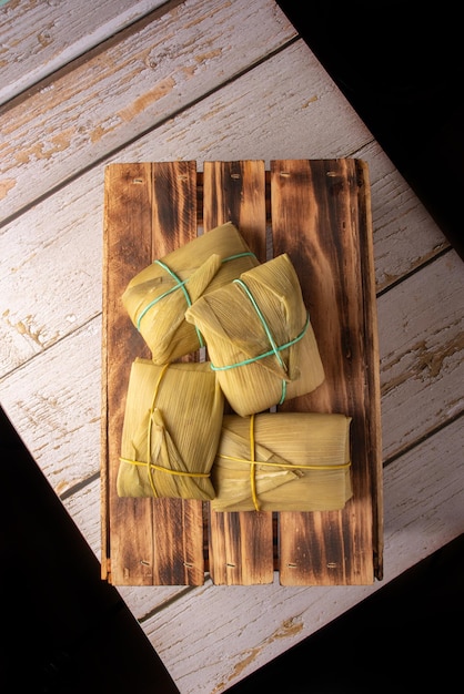 Pamonha cornbased Brazilian food arranged on a rustic wooden table top view