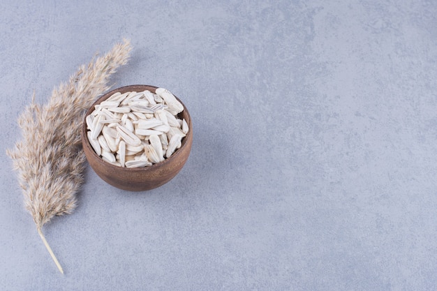 Pampas grass and bowl of sunflower seeds, on the marble.