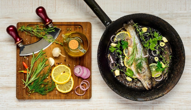 Photo a pan of fish and vegetables with a knife on it