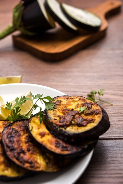 Pan fry crispy baigan or eggplant or brinjal recipe from India. selective focus