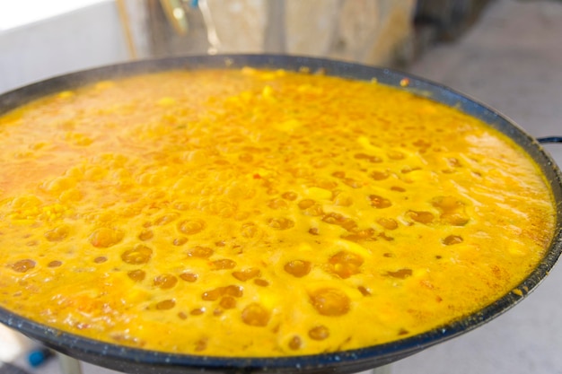 A pan of golden liquid is filled with bubbles.