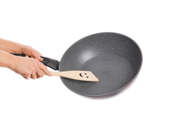 Pan in hands on a white background