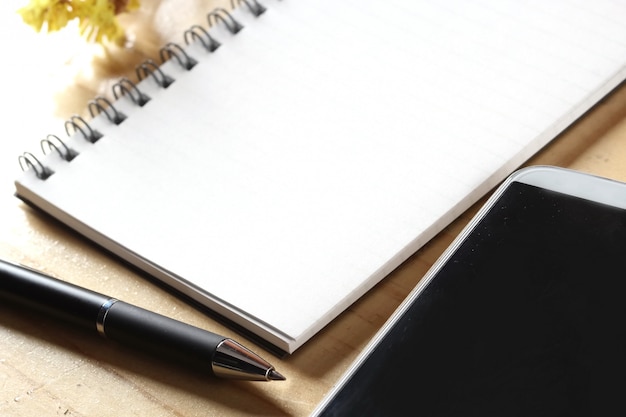 pan and notebook on wooden table