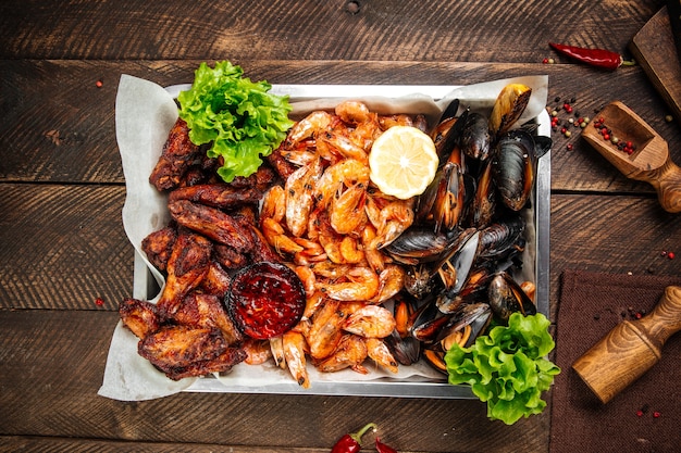 pan with fried shrimp, mussels, and chicken