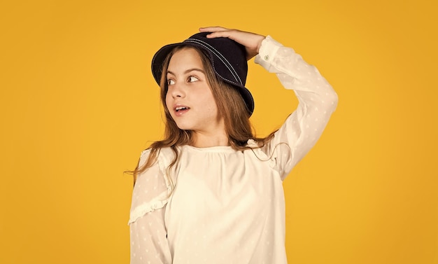 Panama trend Individual style Girl wear hat yellow background Happy kid in hat Fashion accessory Summer accessory collection Child long hair wear hat Accessories shop Outfit inspiration