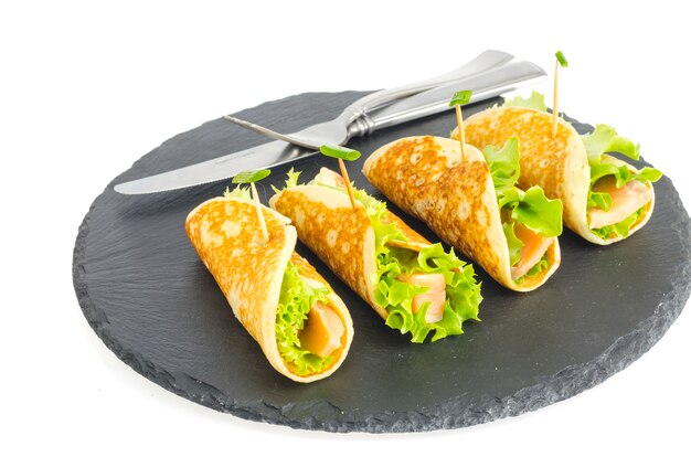 Pancake rolls with fish and lettuce