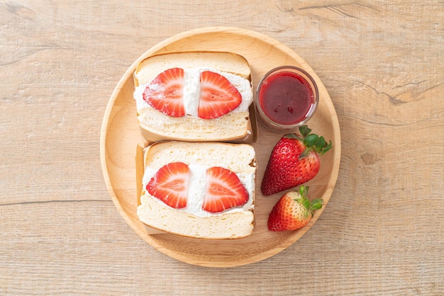 pancake sandwich strawberry fresh cream on wood plate