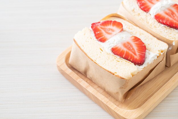 Pancake sandwich strawberry fresh cream on wood plate