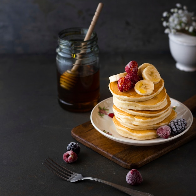 Pancake tower with banana raspberries and honey