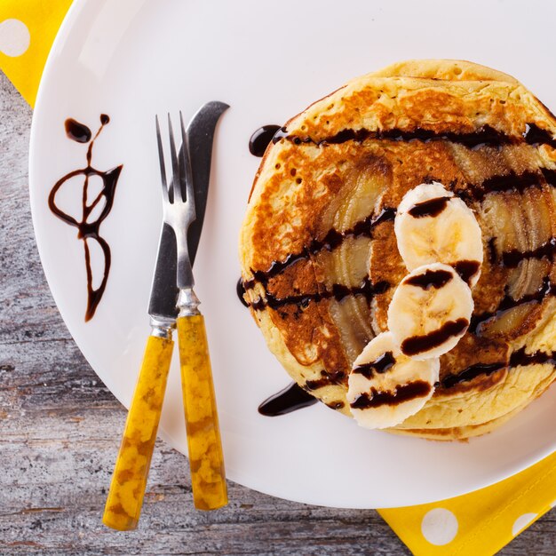 Pancake with banana in chocolate glaze