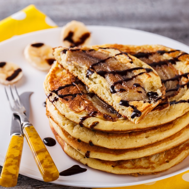 Pancake with banana in chocolate glaze