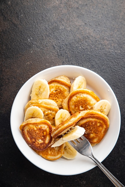 Pancakes banana slices syrup or honey delicious breakfast sweet dessert fresh portion ready to eat