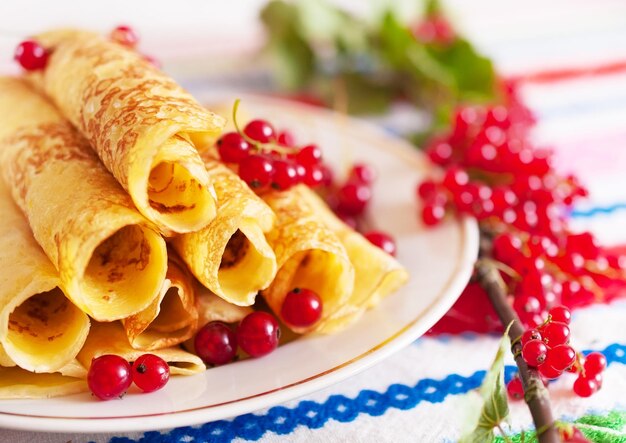 Pancakes and a branch of red currants