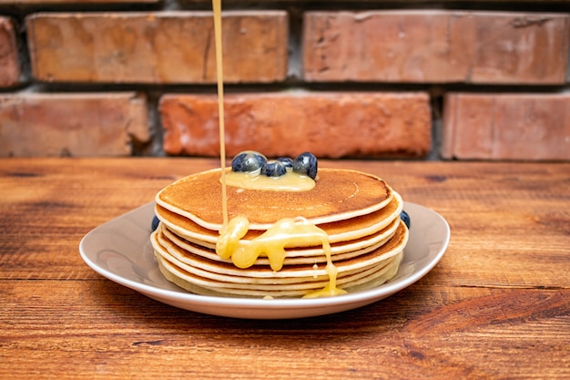 Pancakes on the brown wooden 