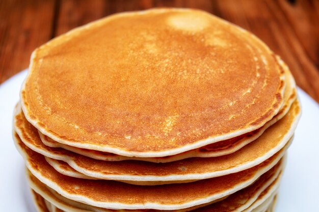 Pancakes on the brown wooden 