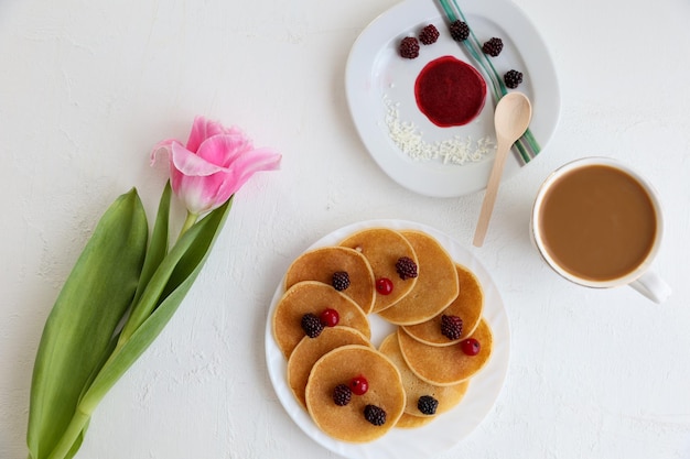 Pancakes coffee flowers and spring inscription