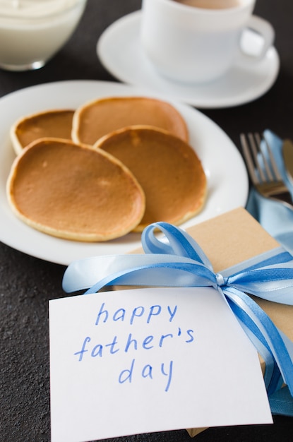 Pancakes and a cup of coffee for father. Father's day concept.