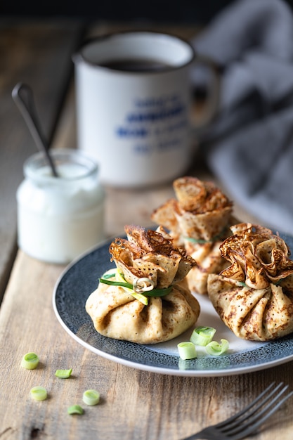 Pancakes in the form of a bag stuffed with eggs and onions