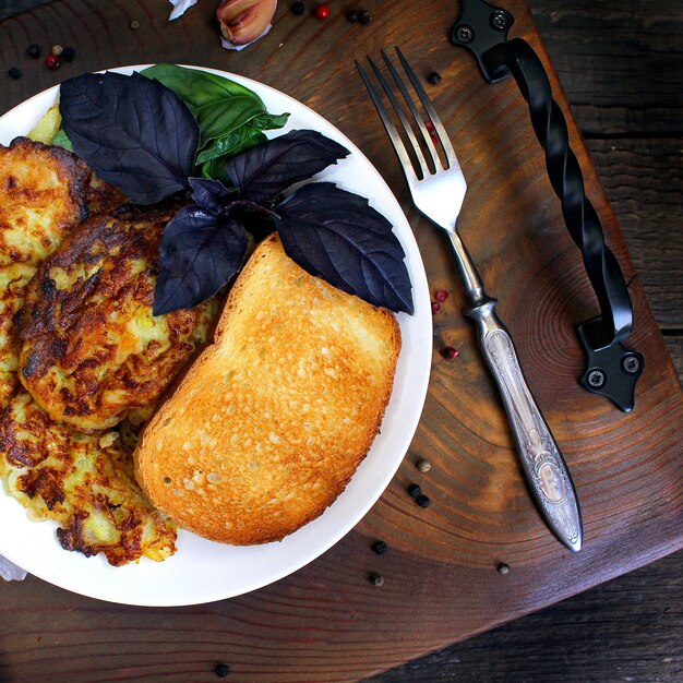 Pancakes from courgettes, garlic, basil. wood