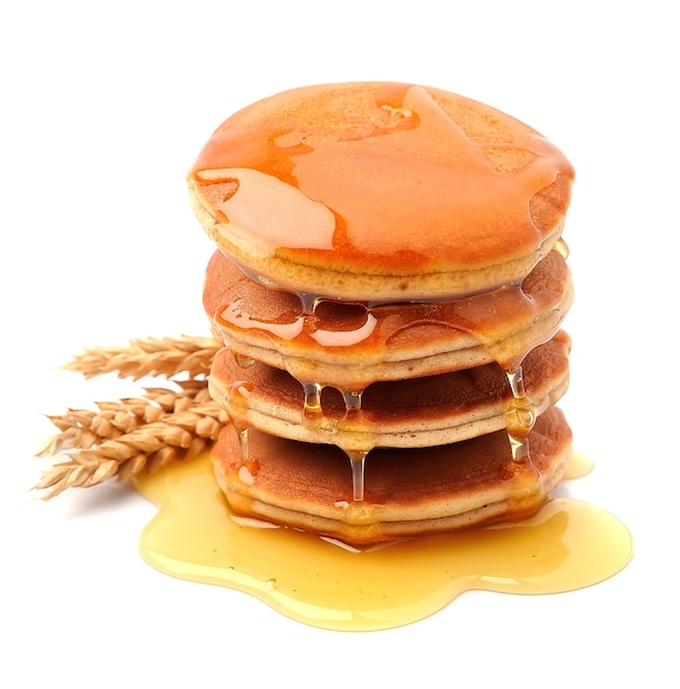 Pancakes in honey syrup on white