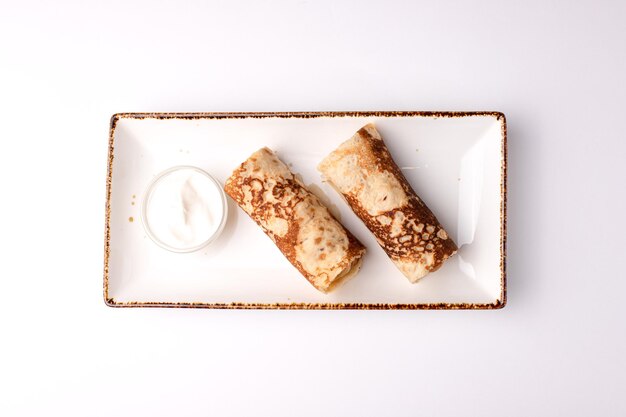 Pancakes pancakes with sour cream food on a white background isolated