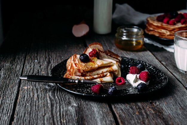 Pancakes on a plate with berries. Breakfast