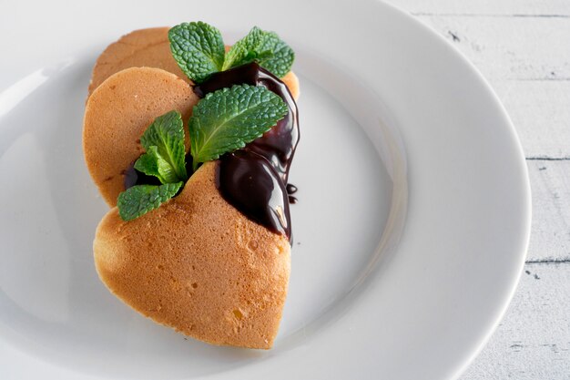 Pancakes in the shape of a heart with chocolate.