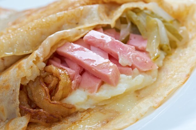 Pancakes stuffed ham and potatoes,onion,cucumber. Shallow depth-of-field.