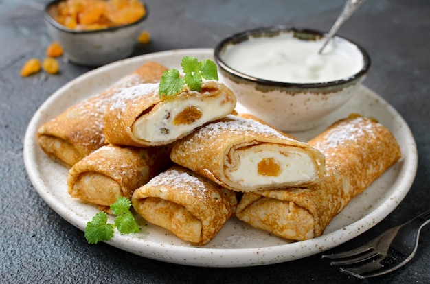 Pancakes stuffed with cottage cheese and raisins