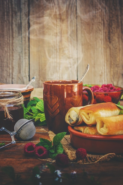 Pancakes and tea on a wooden background. Selective focus.