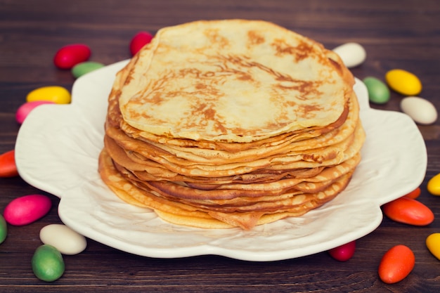 Pancakes on white dish on wooden