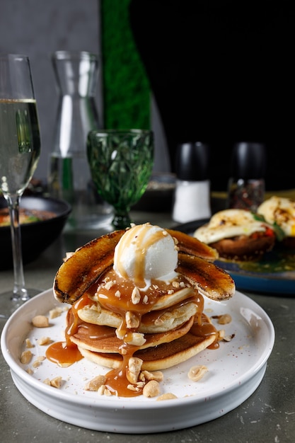 Pancakes with banana, caramel and ice cream scoop