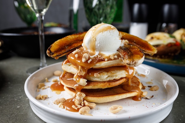 Pancakes with banana, caramel and ice cream scoop