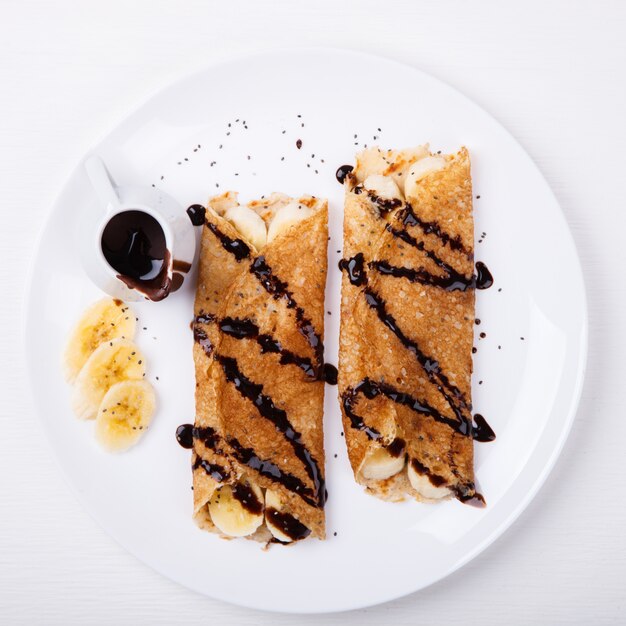 Pancakes with banana and chocolate topping