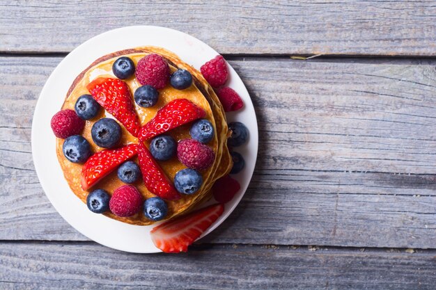 Pancakes with berries blueberries raspberry and strawberry