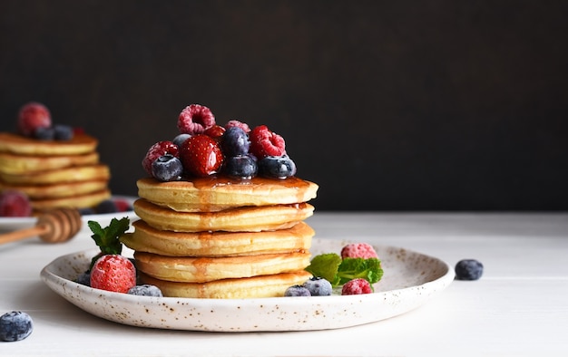 Pancakes with berries and maple syrup